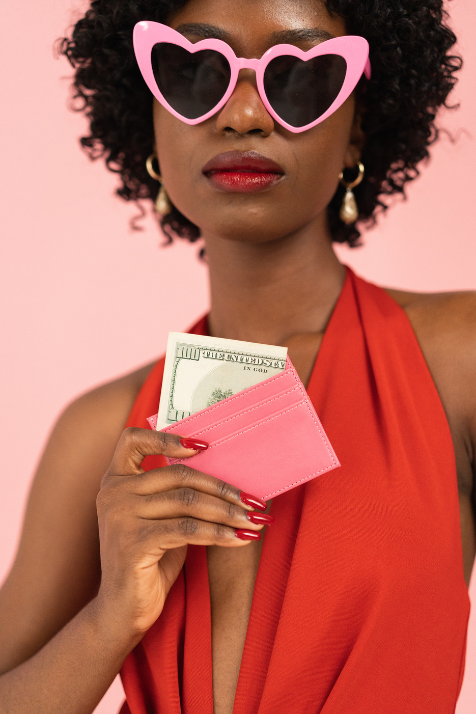 Stylish Woman Holding a Pink Wallet with Cash
